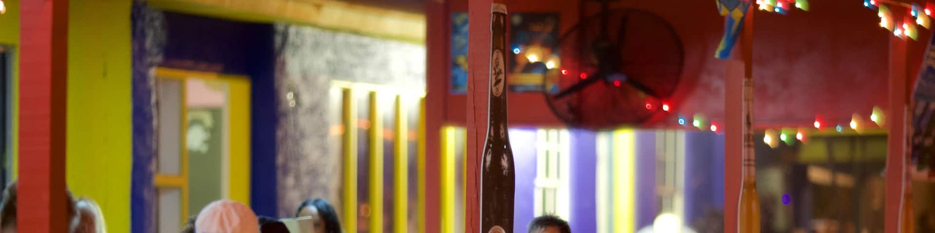 Smith Point showing night scenes, outdoor eating and a beach bar