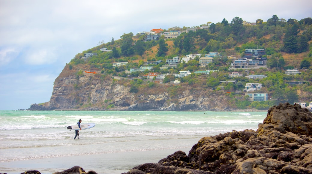 Sumner Beach which includes rugged coastline, a coastal town and surfing