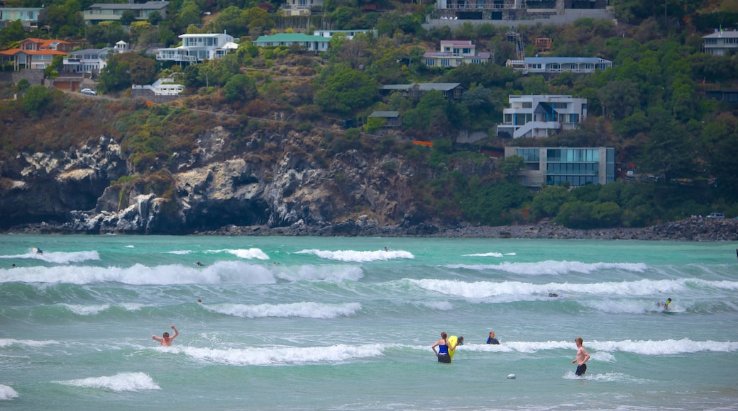 Sumner Beach featuring waves, swimming and a coastal town