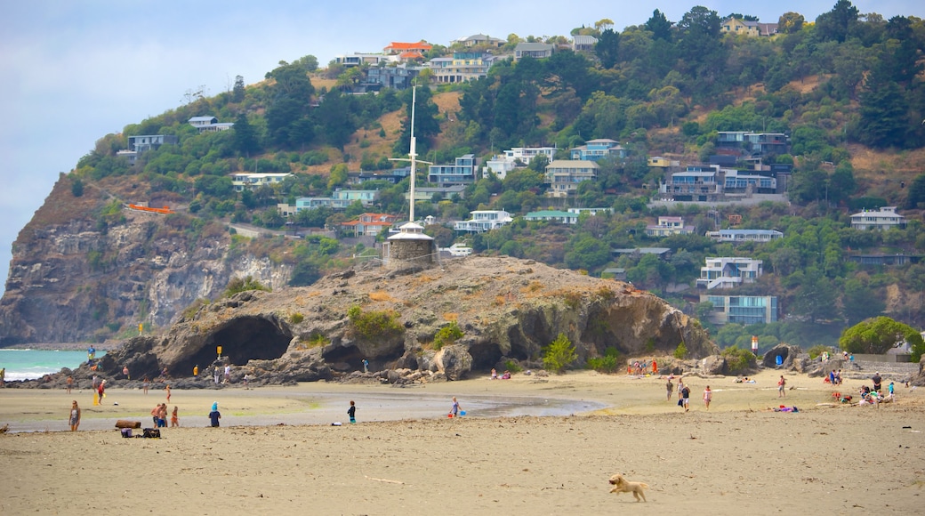 Cave Rock featuring a coastal town, caves and a beach