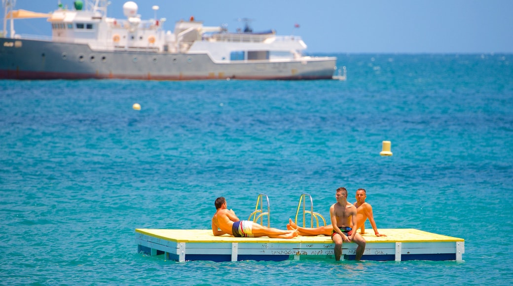 Baie des Citrons featuring swimming as well as a small group of people