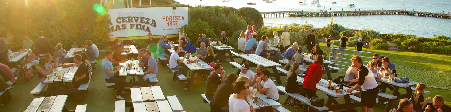 Portsea welches beinhaltet Sonnenuntergang und Essen im Freien sowie große Menschengruppe