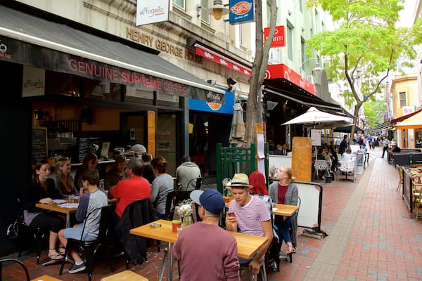 Hardware Lane showing outdoor eating and café scenes as well as a large group of people
