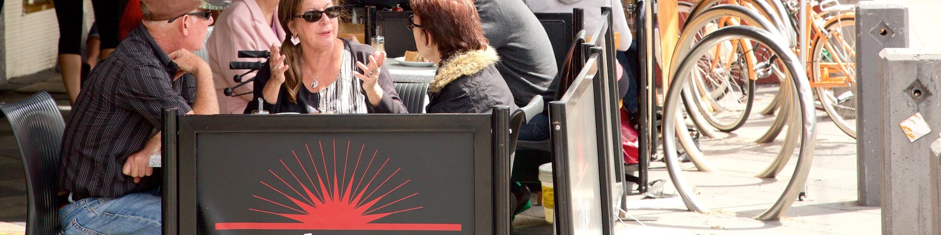 Acland Street featuring cafe scenes and outdoor eating as well as a large group of people