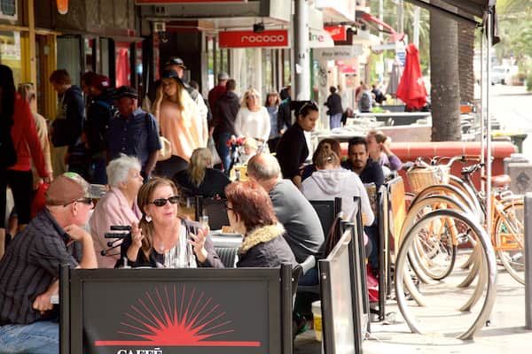 Acland Street showing café scenes and outdoor eating as well as a large group of people