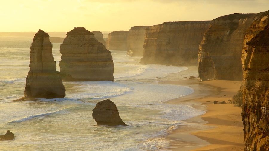 Twelve Apostles which includes rugged coastline, a sunset and a gorge or canyon
