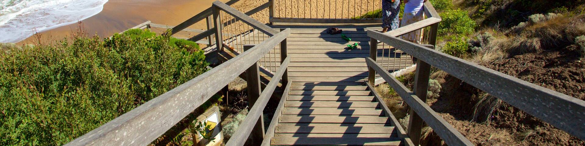 Bell\'s Beach which includes a sandy beach and views as well as a small group of people