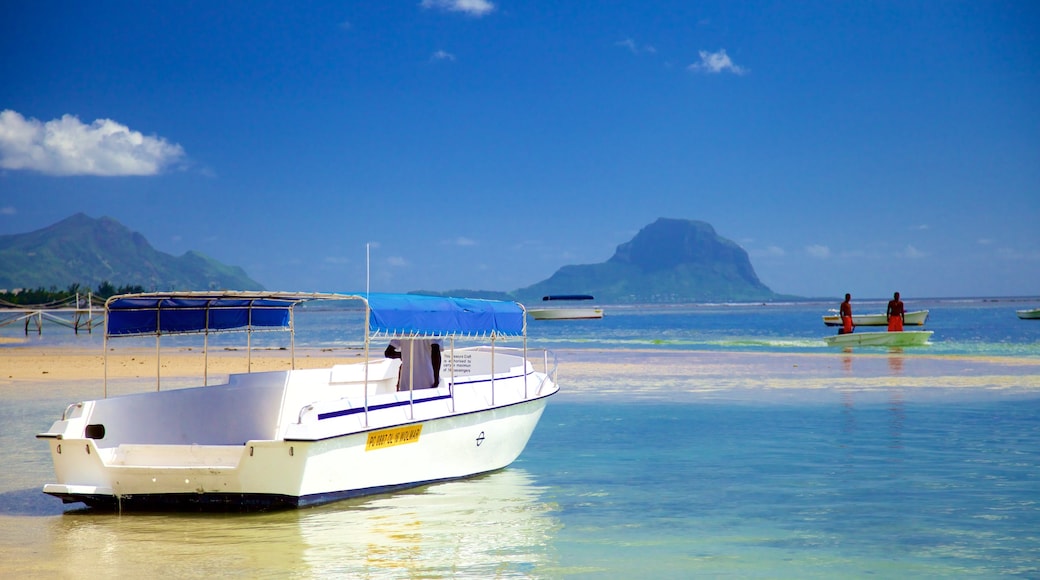 Flic-en-Flac showing general coastal views and boating as well as a small group of people