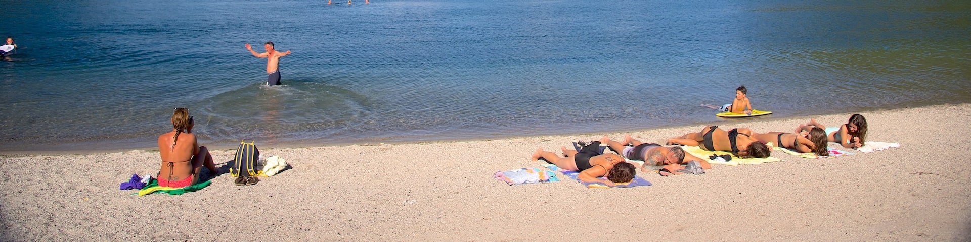 Lake Tarawera showing swimming and a beach as well as a small group of people