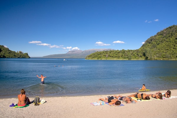 Lake Tarawera which includes swimming and a beach as well as a small group of people