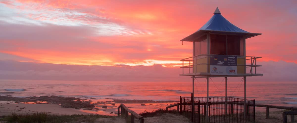 The Entrance featuring a sunset and a sandy beach