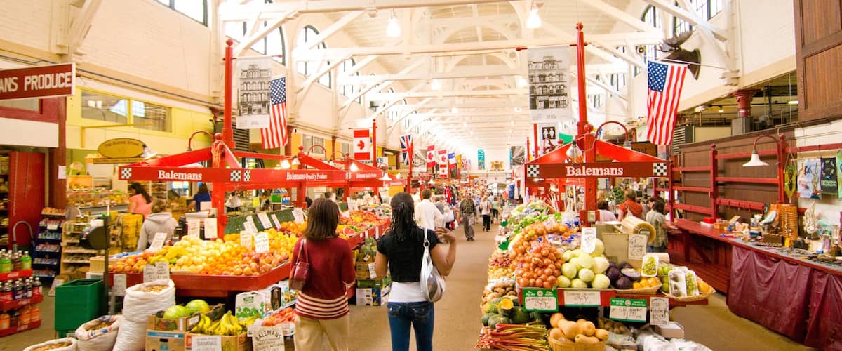 Saint John featuring markets and interior views as well as a small group of people