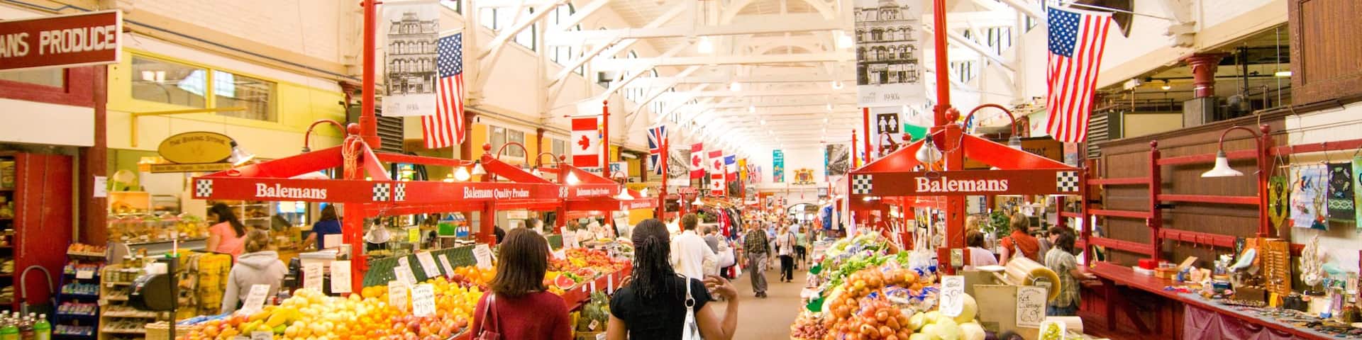 Saint John featuring markets and interior views as well as a small group of people