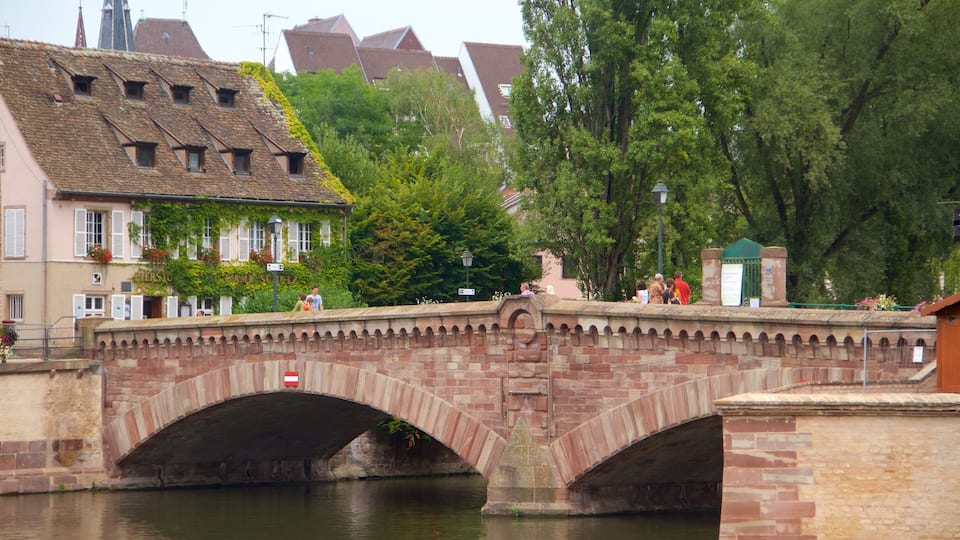 Covered Bridge featuring a small town or village, a river or creek and a bridge