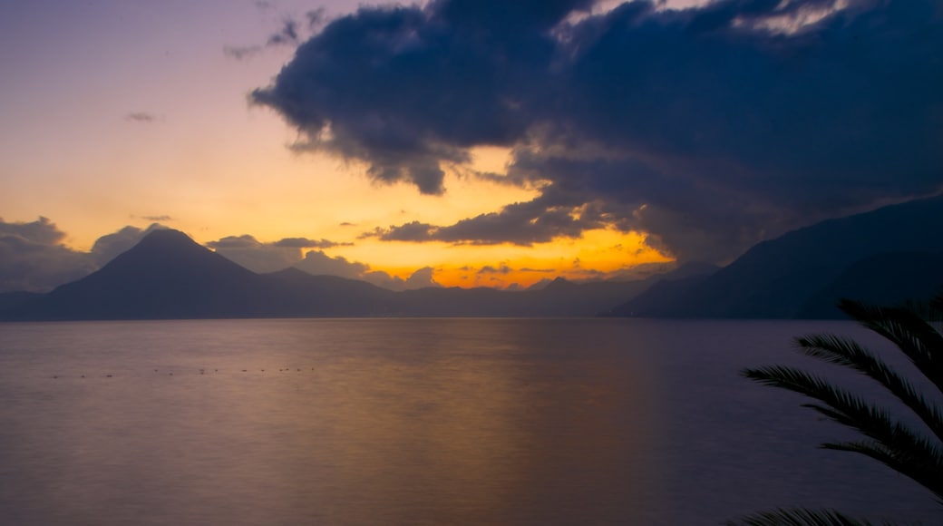 Atitlan Volcano which includes general coastal views, mountains and a sunset