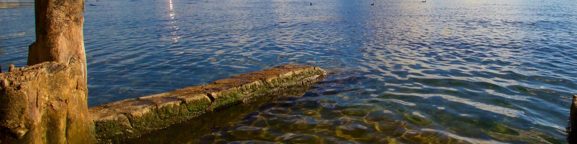 Atitlan Volcano featuring a bay or harbor, mountains and general coastal views