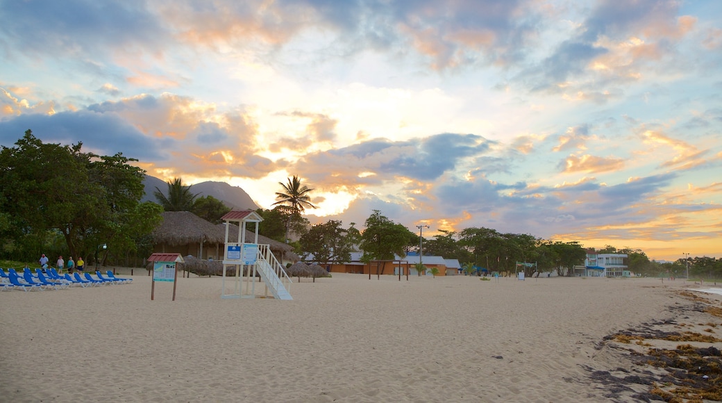 Playa Dorada showing a sunset and a sandy beach