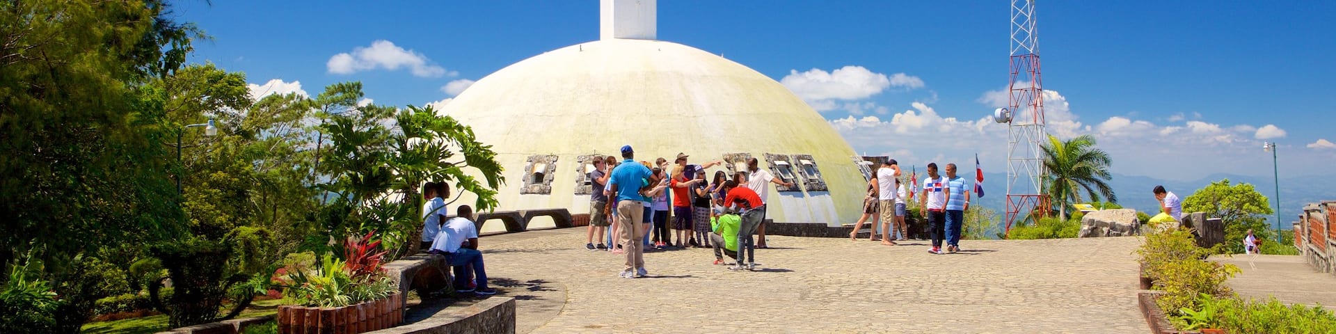 Pico Isabel de Torres featuring religious elements and a statue or sculpture as well as a small group of people