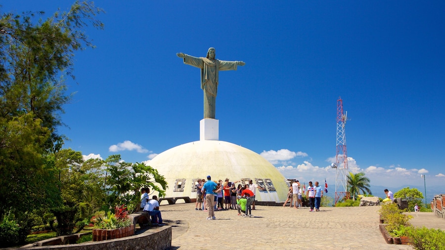 Pico Isabel de Torres featuring religious elements and a statue or sculpture as well as a small group of people