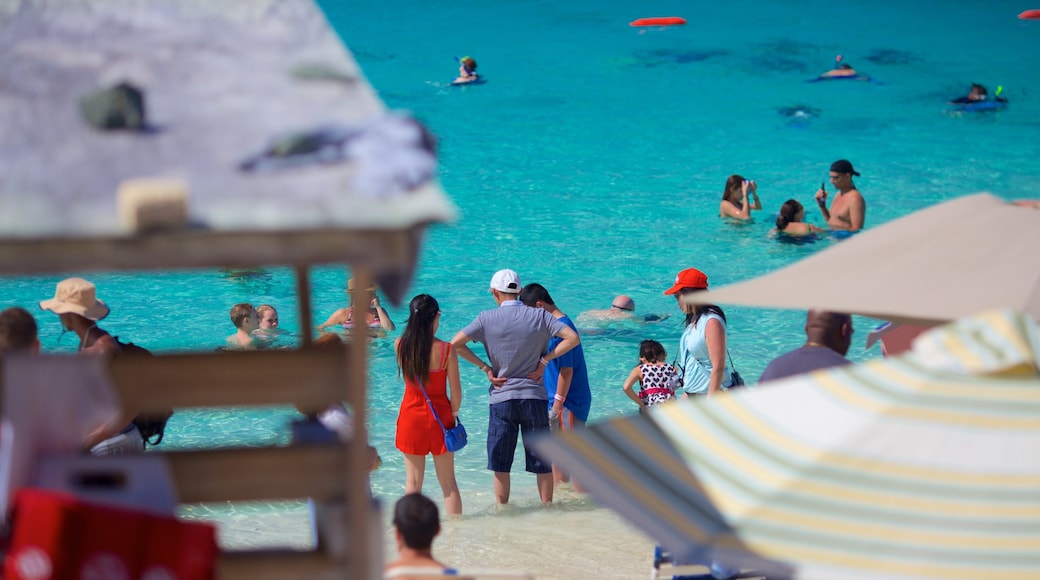 Coki Beach showing a beach as well as a small group of people