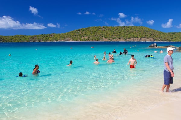 Coki Beach showing a sandy beach as well as a small group of people