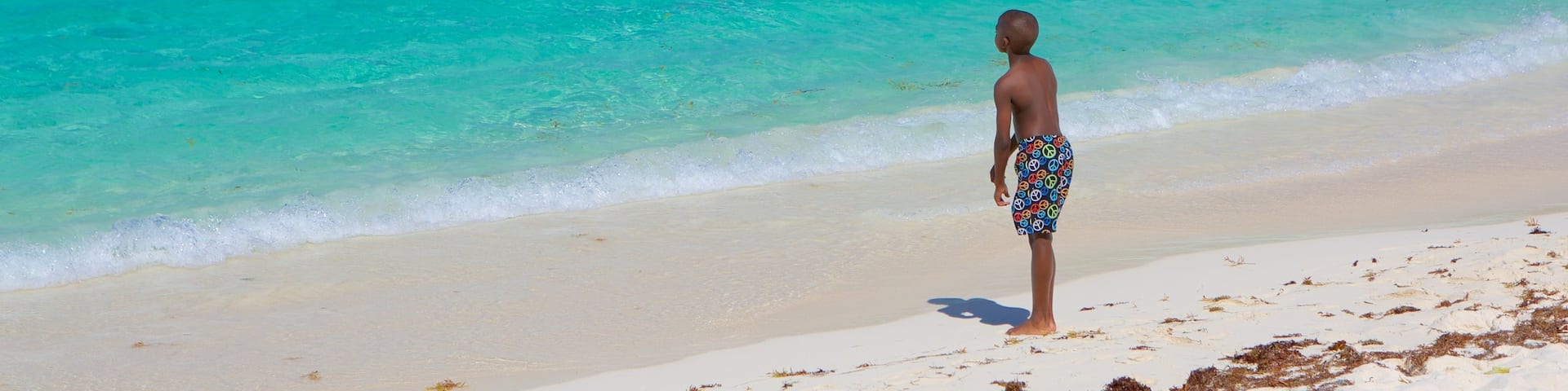 Smith Bay Beach featuring a beach as well as an individual child
