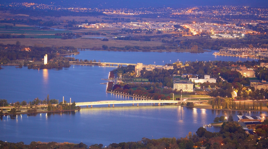 Telstra Tower which includes a city, a lake or waterhole and night scenes