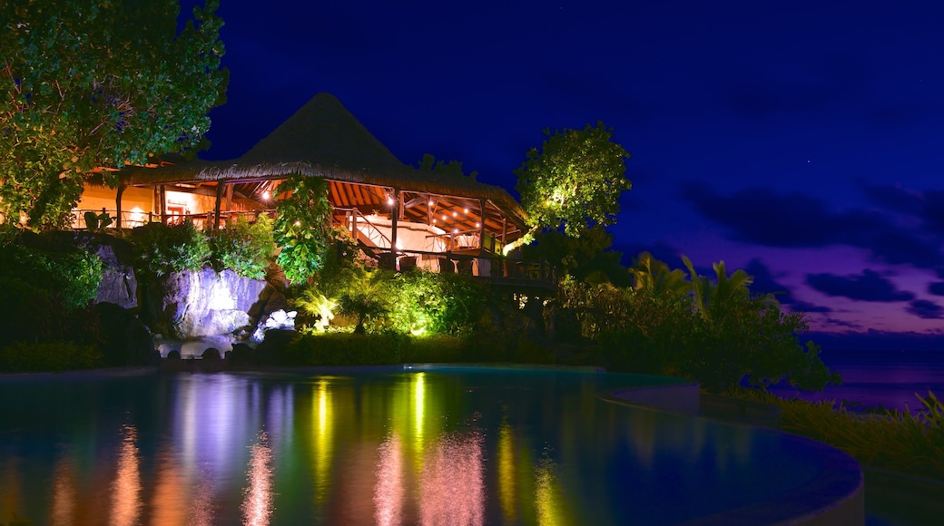 Aitutaki which includes night scenes and a pool