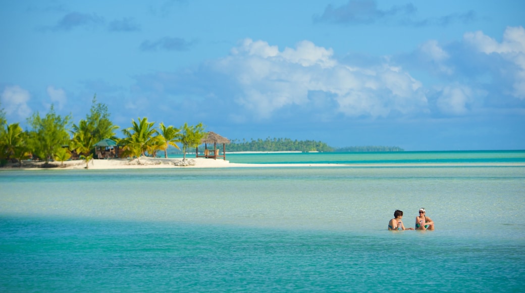 Aitutaki showing general coastal views as well as a small group of people