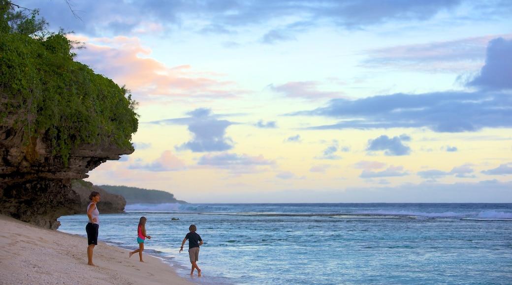 Atiu showing rugged coastline as well as a family