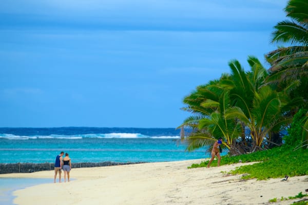 Aro\'a Beach showing a sandy beach as well as a couple