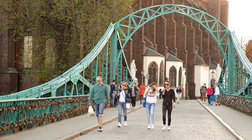 Wroclaw showing a bridge as well as a small group of people