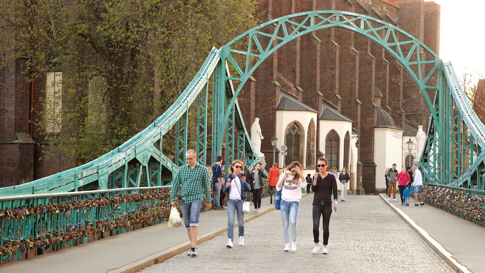 Wroclaw showing a bridge as well as a small group of people