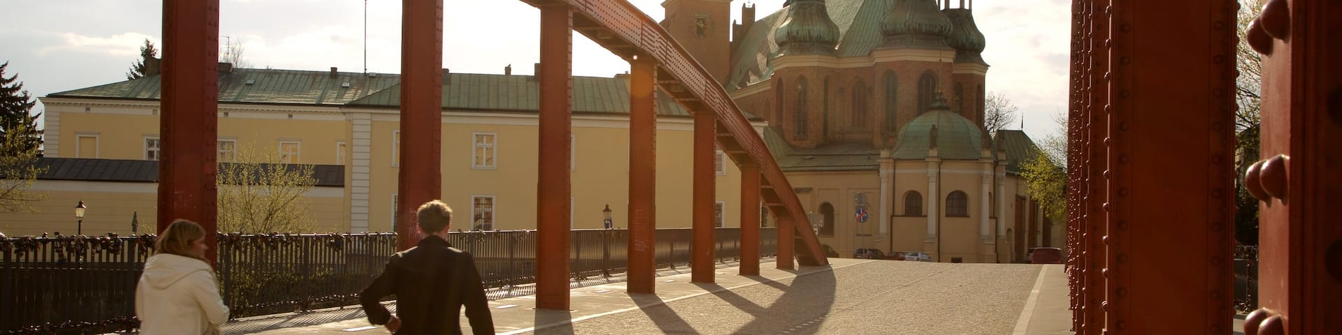 Poznan featuring a bridge as well as a small group of people