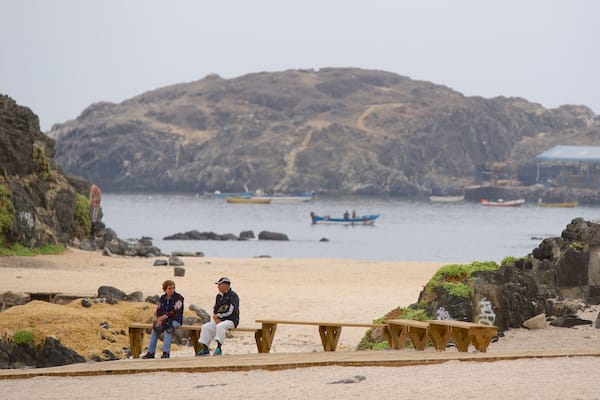 Bahia Inglesa Beach featuring a lake or waterhole as well as a small group of people