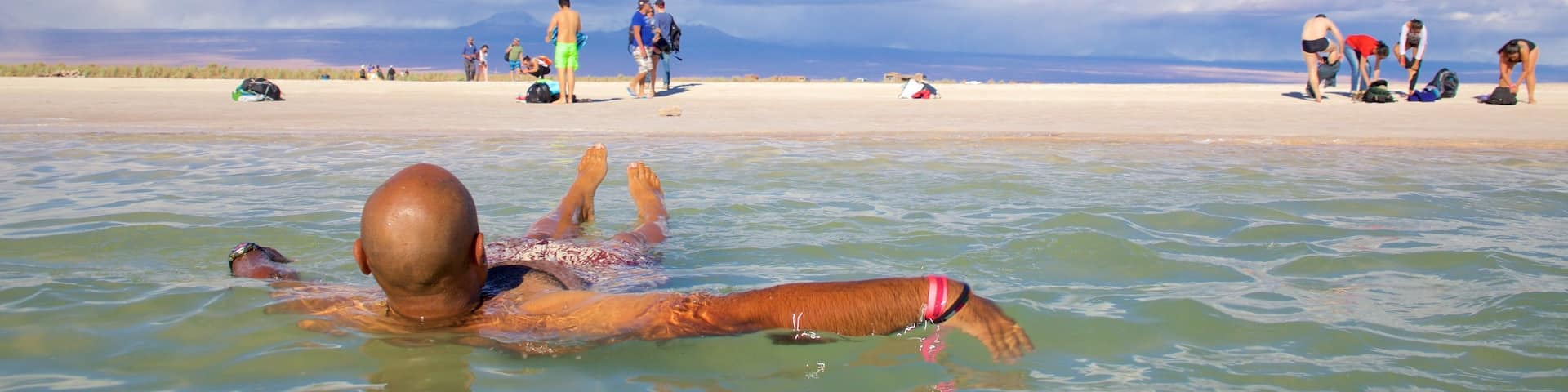 Cejar Lagoon featuring swimming and a sandy beach as well as an individual male