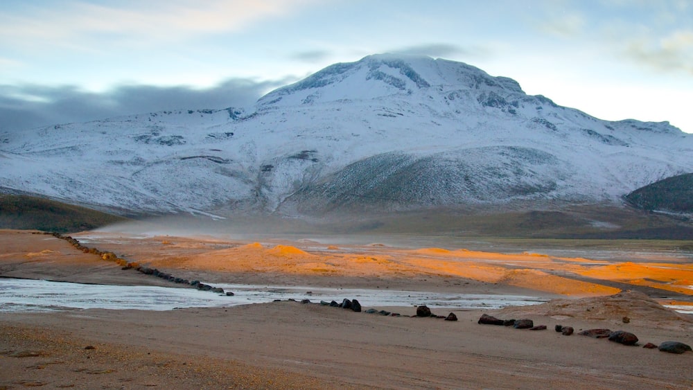 El Tatio Geyser Field showing mountains, a sunset and snow