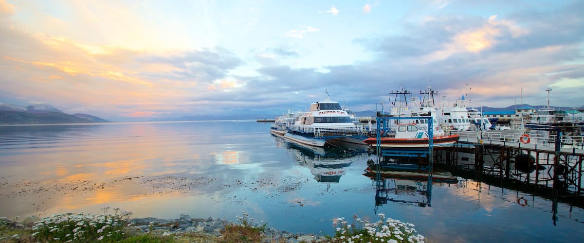 Ushuaia showing a marina, a sunset and a lake or waterhole
