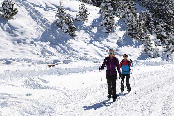 Meribel Ski Resort showing snow and snow skiing as well as a small group of people