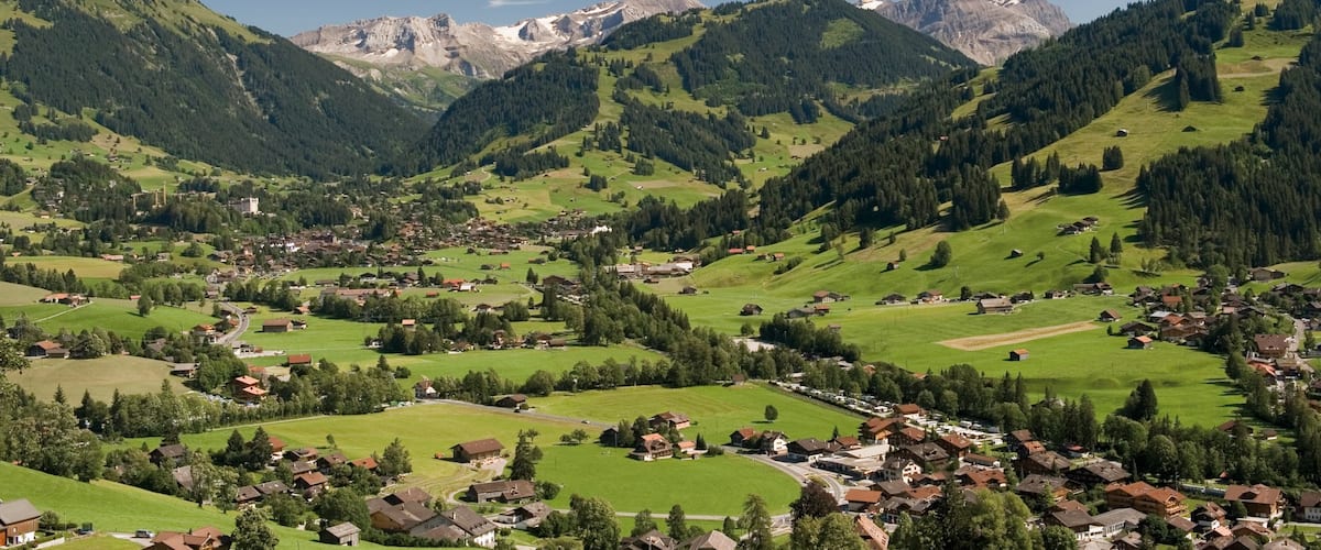 Gstaad which includes a small town or village, tranquil scenes and mountains