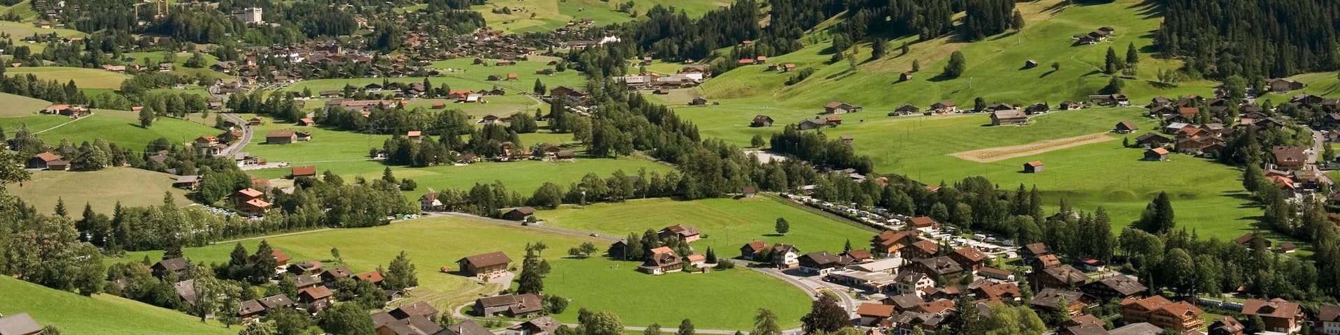 Gstaad which includes a small town or village, tranquil scenes and mountains