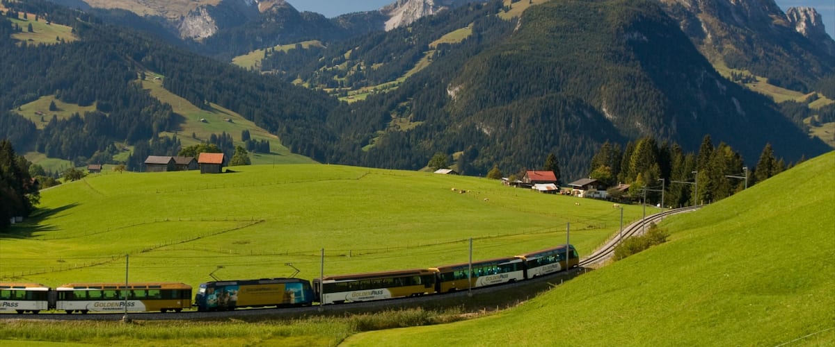 Gstaad which includes railway items, mountains and tranquil scenes