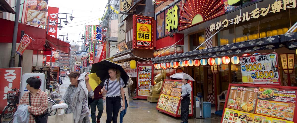 Shinsekai showing a city as well as a small group of people