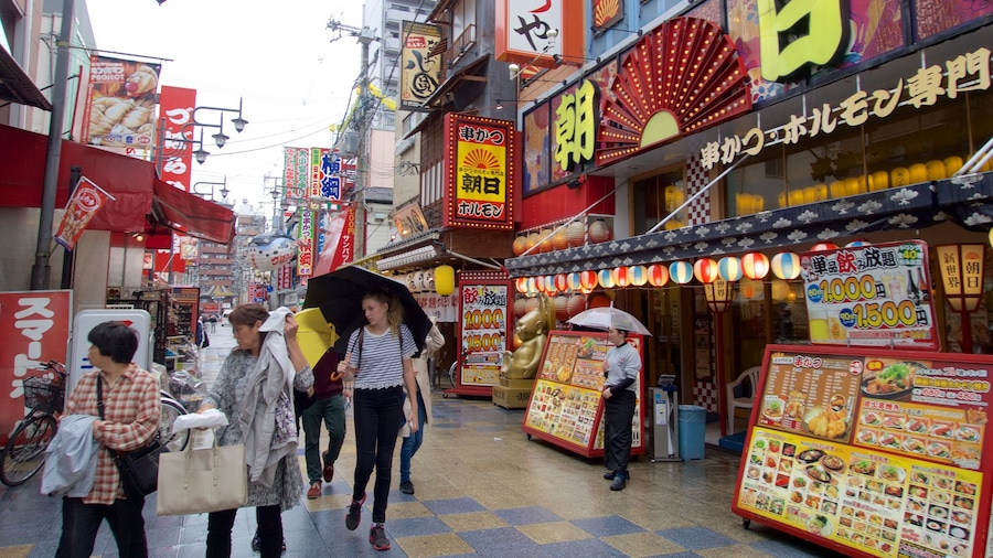 Shinsekai showing a city as well as a small group of people