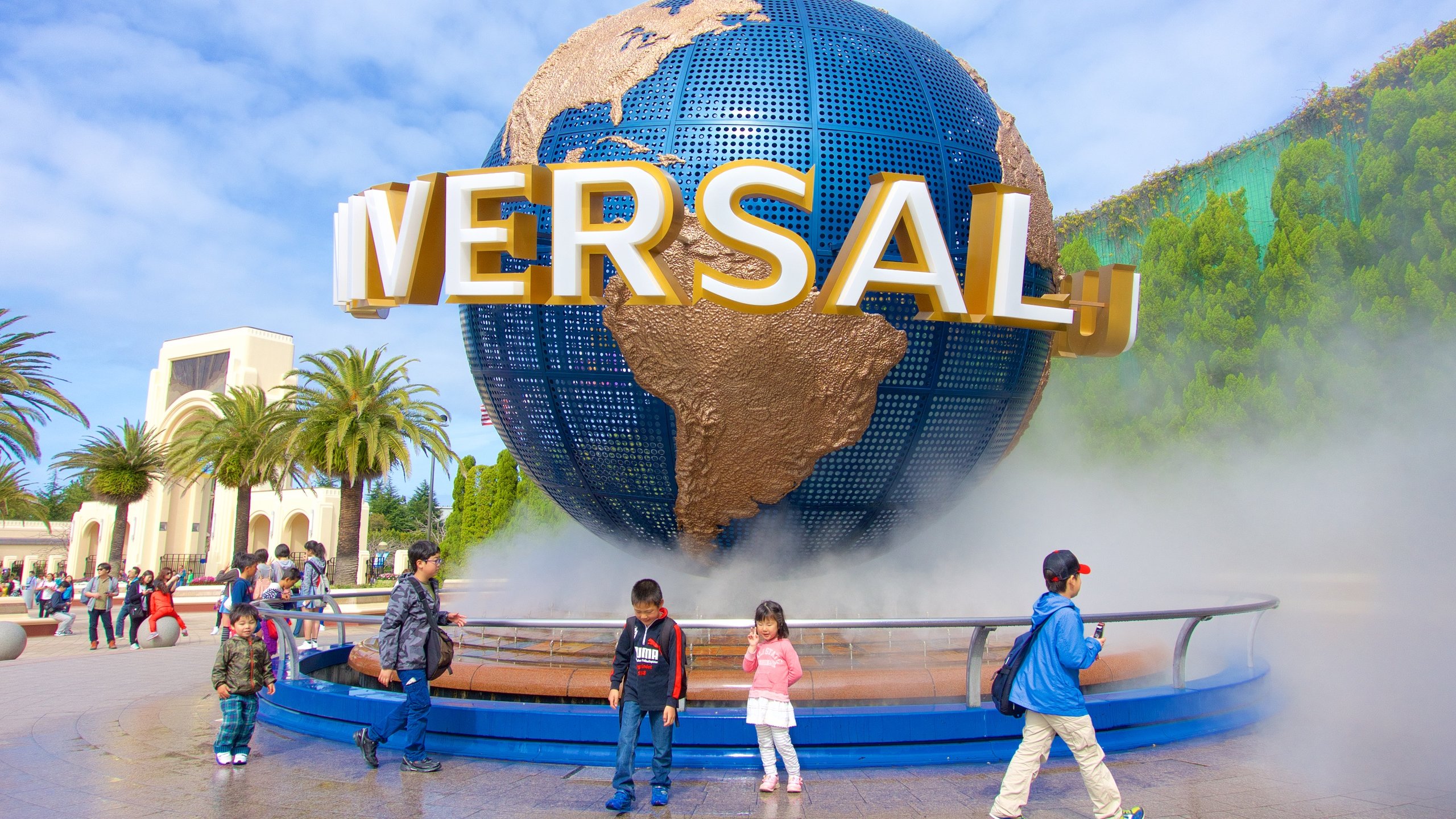 Universal Studios Japan® toont een standbeeld of beeldhouwwerk en een fontein en ook kinderen