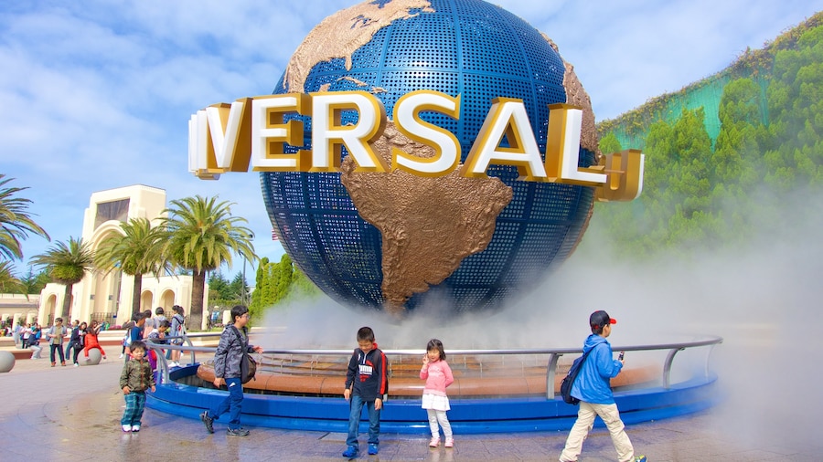 Universal Studios Japan® showing a fountain and a statue or sculpture as well as children