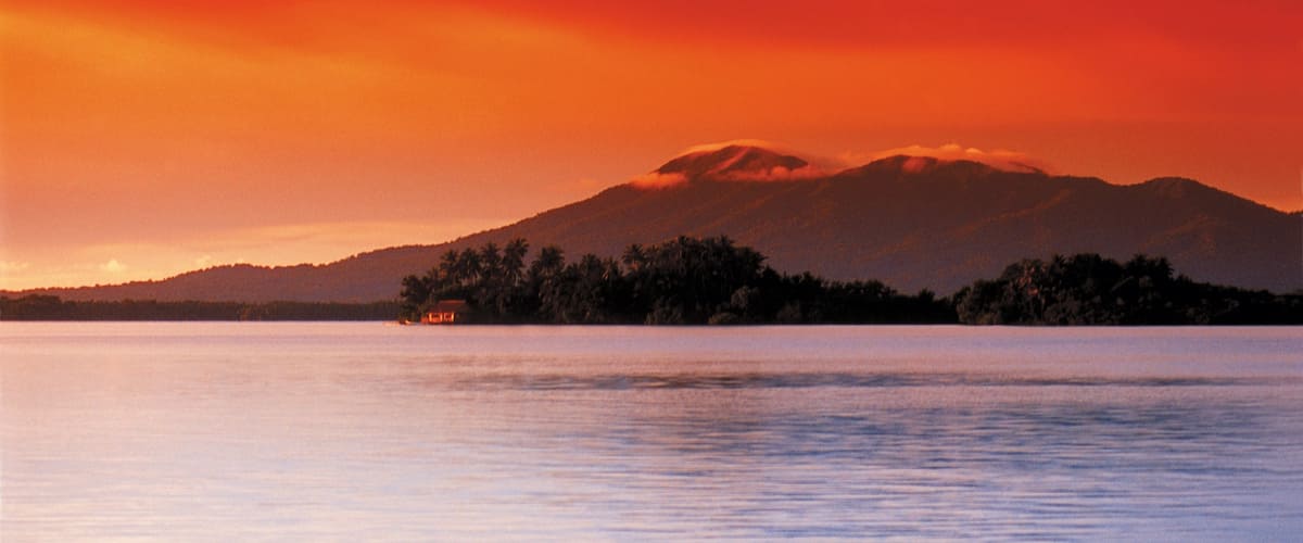 Solomon Islands showing a sunset, general coastal views and mountains