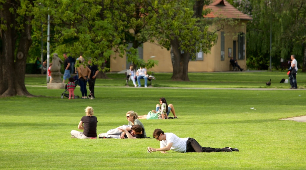 Kampa Park showing a garden as well as a small group of people