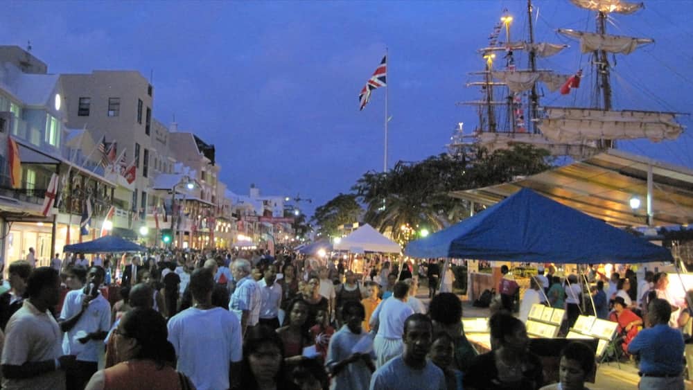 Bermuda showing night scenes and markets as well as a large group of people