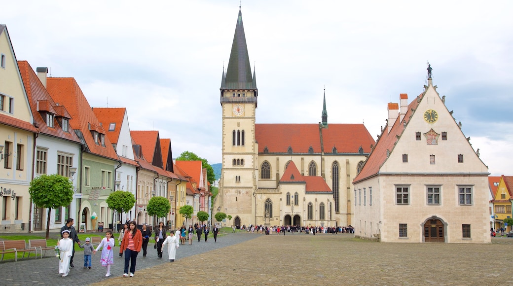 Church of St. Aegidius which includes a city and a square or plaza as well as a small group of people